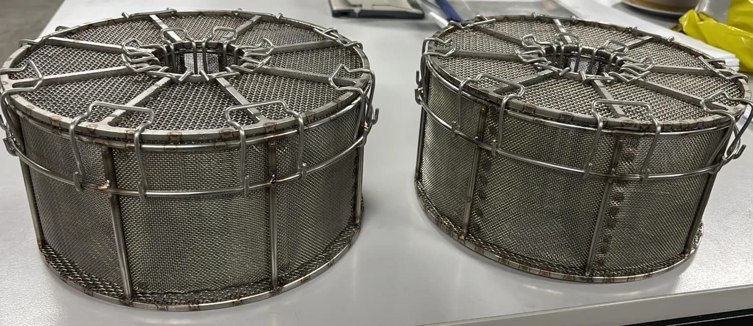 Two stainless steel canisters with fine mesh, rings, spokes and fastening clips